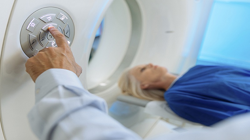 Radiologic technician and Patient being scanned and diagnosed on CT